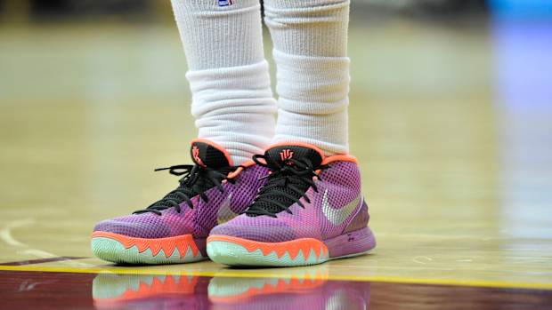 View of Kyrie Irving's purple and orange Nike shoes.